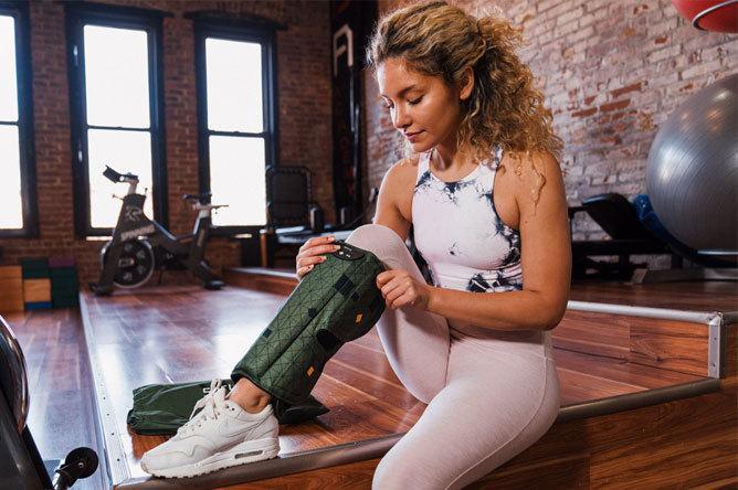 A woman starts up her Spryng before a workout