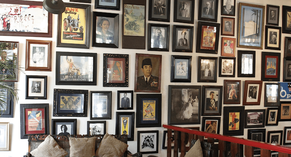 The wall of pictures at Cafe Batavia, home to the best ginger coffee in Jakarta